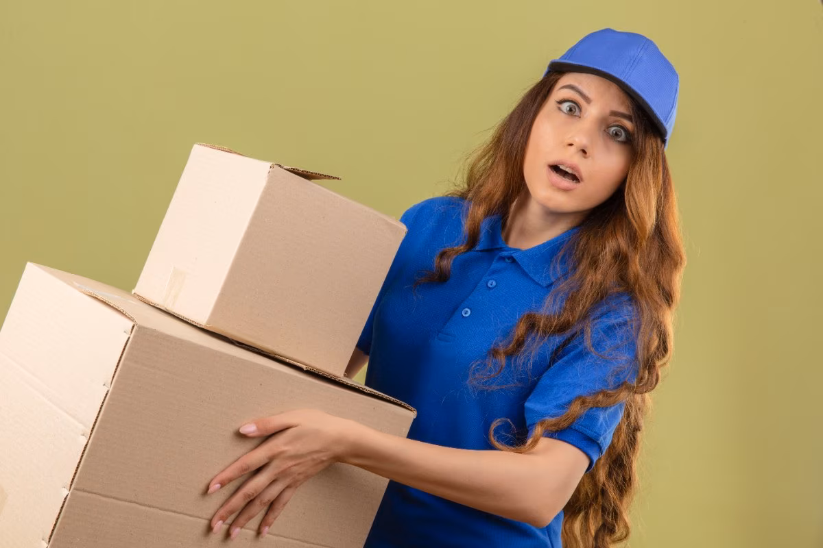 Forest Movers crew member in uniform ready with moving boxes
